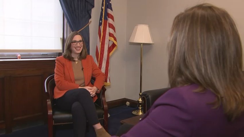 Congresswoman Sarah McBride faces the camera and smiles while speaking with NBC10's Lauren Mayk who has her back to the camera.